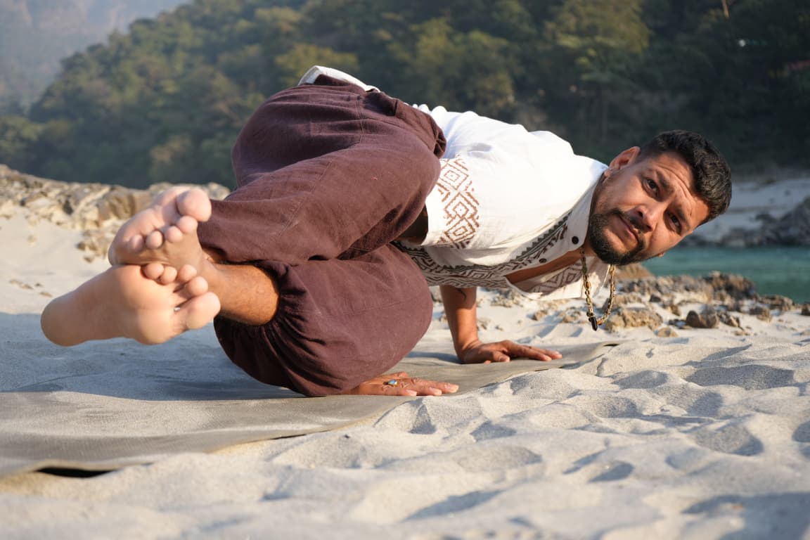 Arun Maan practising yoga beside the river