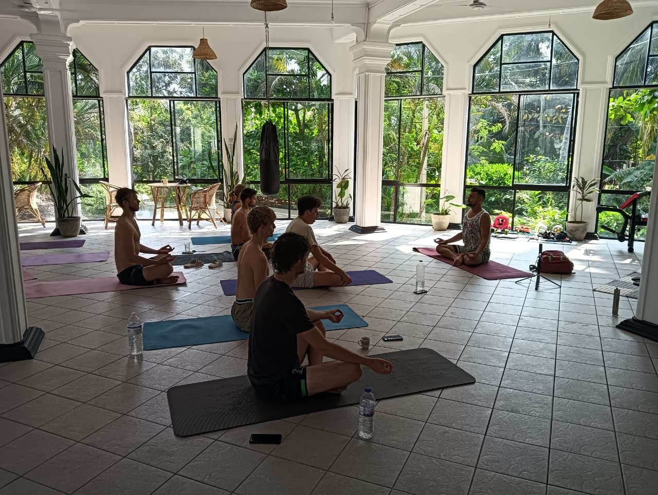 A yoga group practising together in a bright retreat room